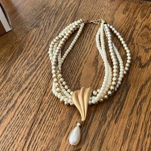 Costume jewelry pearls in off-white and gold with a gold brooch drop pearl